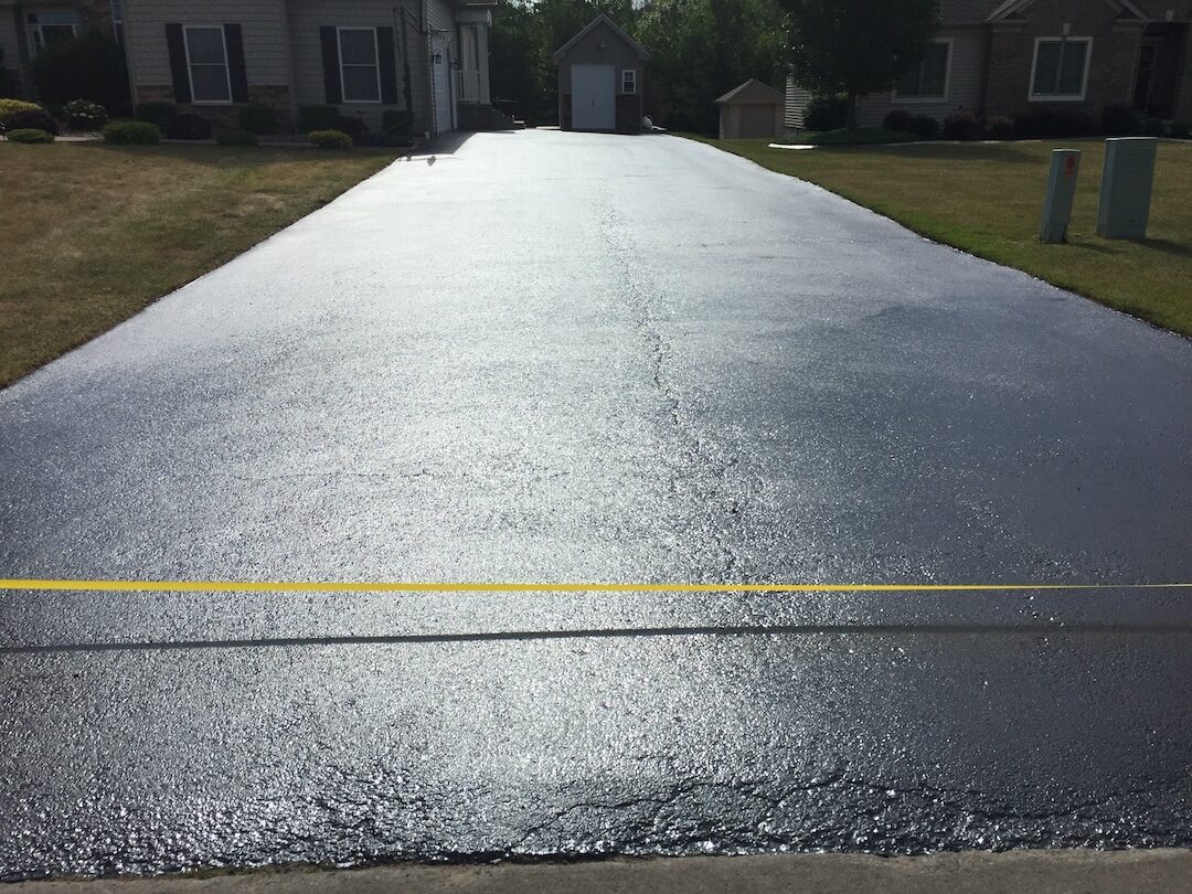 Freshly sealed asphalt driveway in Rochester NY
